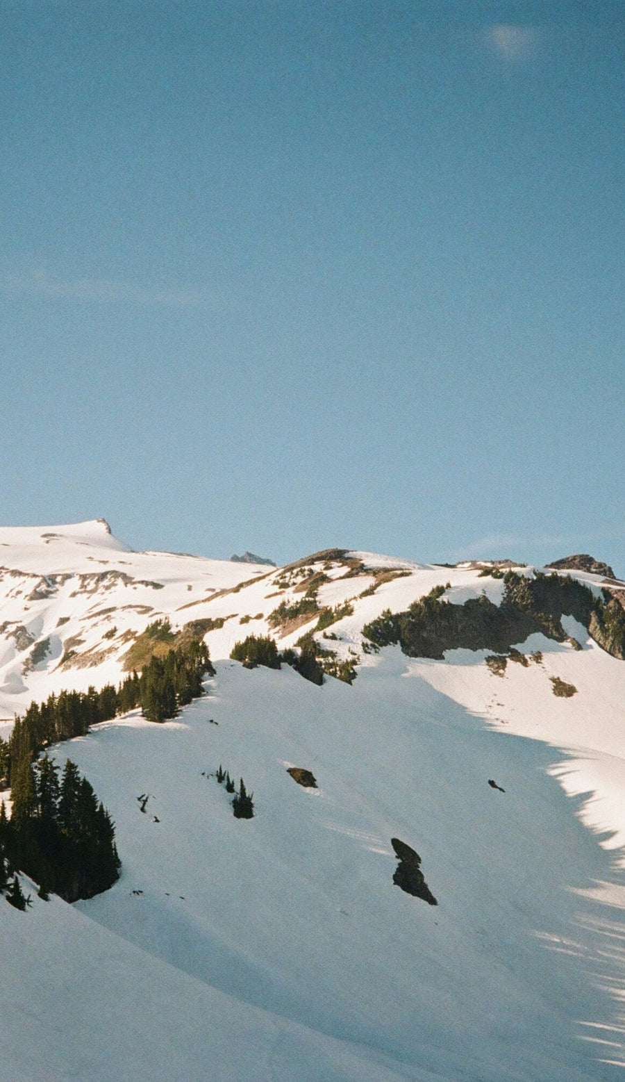 Snowy mountain peak with clear blue sky