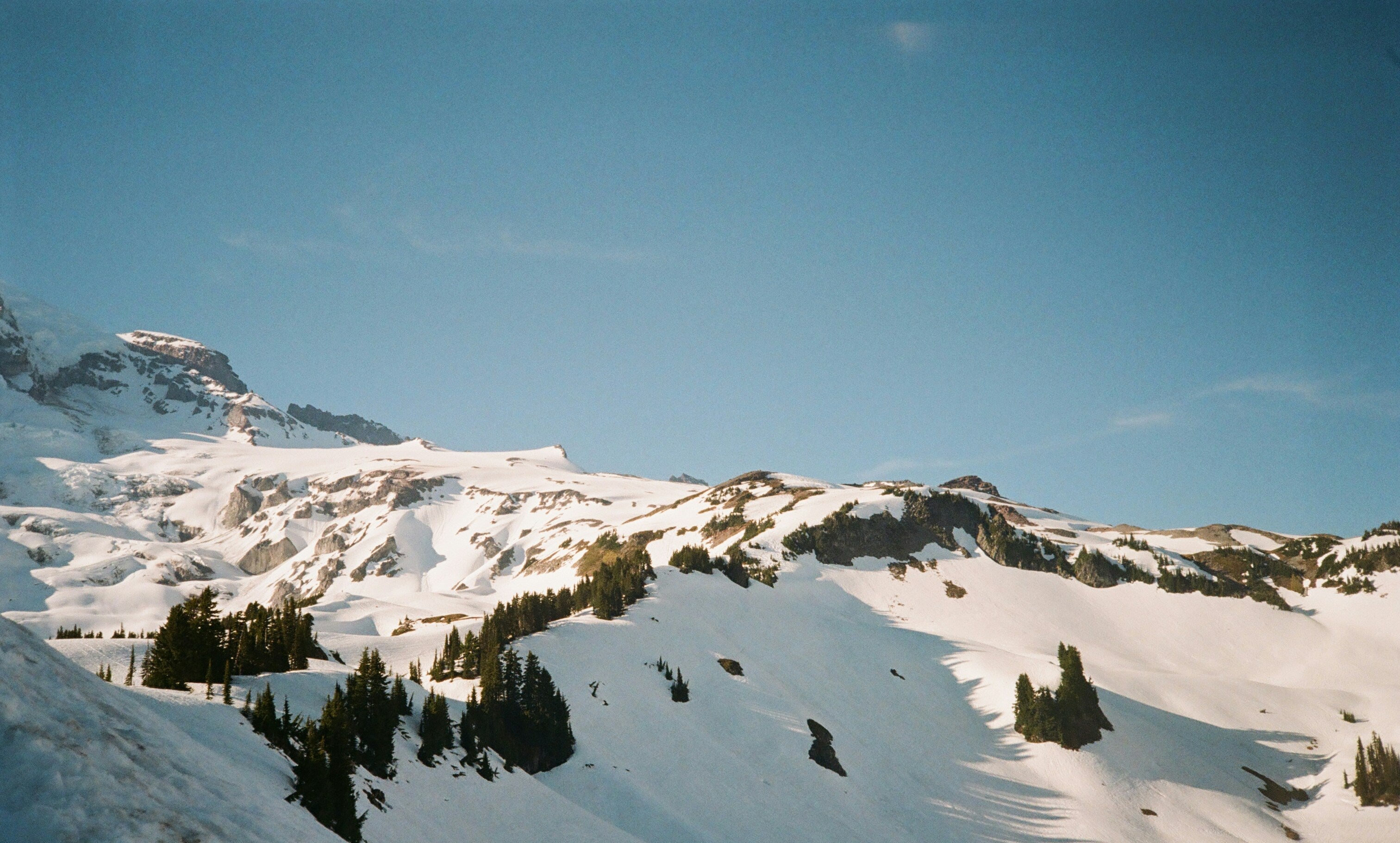 Snowy mountain landscape with clear blue sky